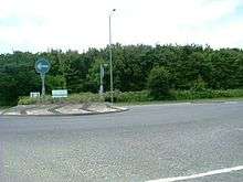 Denham Roundabout, with a blue one-way road sign
