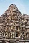 Very tall stone structure decorated all over with sculptures.