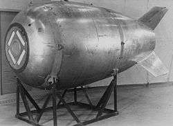 A large bomb resting on a cradle