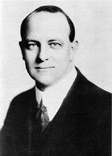 Black and white photograph of Wodehouse's head and shoulders. He is wearing a suit and looking at the camera