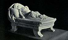 Monument of infant girl asleep on a couch