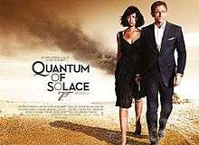 Empire Design's poster for Quantum of Solace shows James Bond (Daniel Craig), wearing a business suit and holding a gun, with Camille Montes (Olga Kurylenko), who wore a black dress. Both are walking away from a destroyed facility in the desert. To their left is the title "Quantum Of Solace" in black letters – except the 'O's, which are golden and make a diagonal straight line with a 7 forming the 007 gun logo. Below the title is the film's main credits