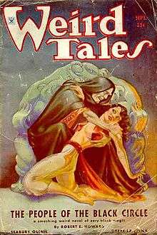 Magazine cover showing a hooded man menacing a terrified woman
